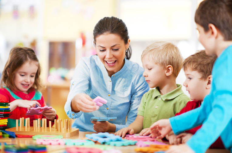 Childminder playing with children